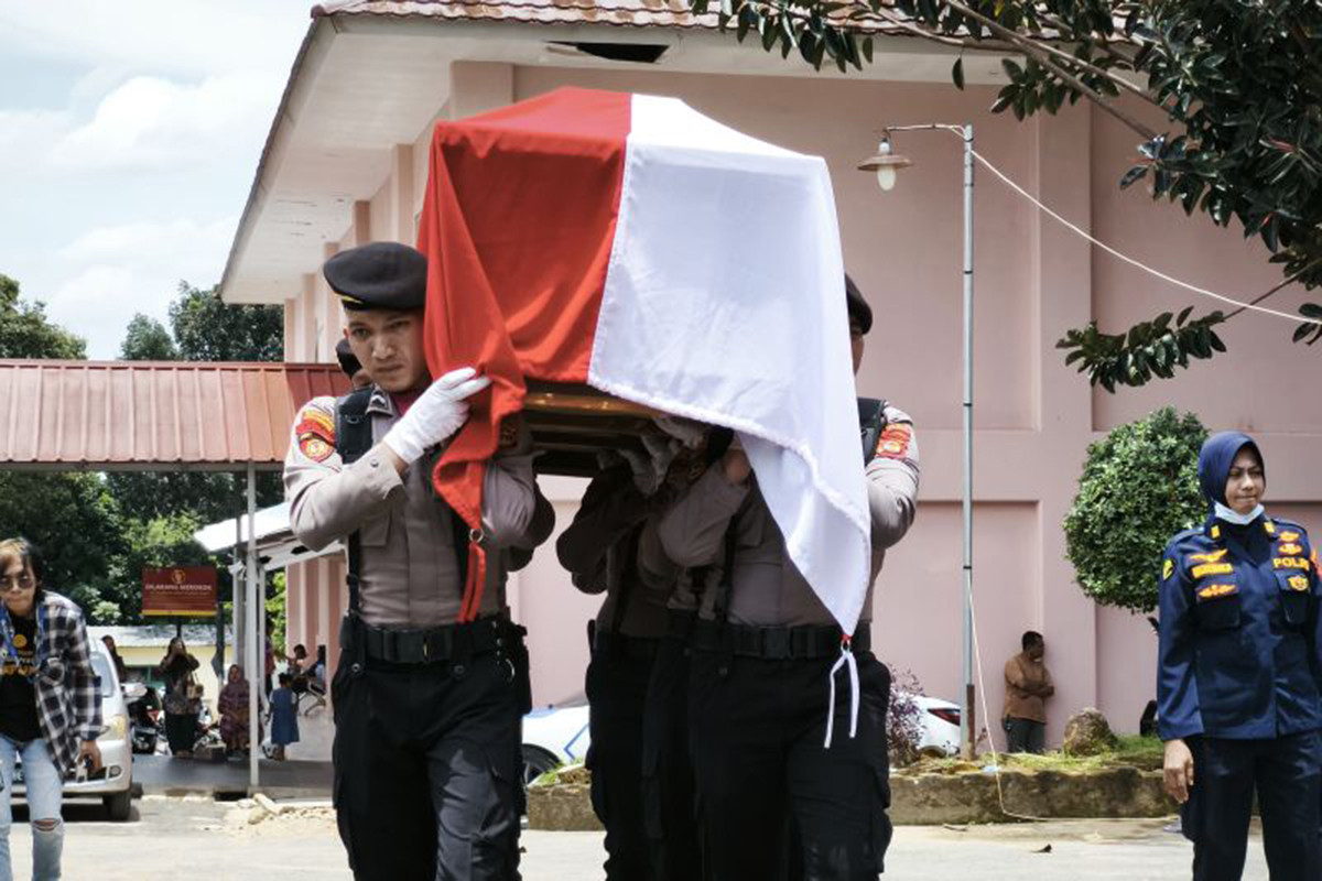 Personel kepolisian sedang mengangkut jenazah anggota polri yang meninggal dunia saat melakukan penggerebekan judi sabung ayam di Kabupaten Way Kanan. Lampung, Selasa (18/3/2025). (ANTARA/Dian Hadiyatna)